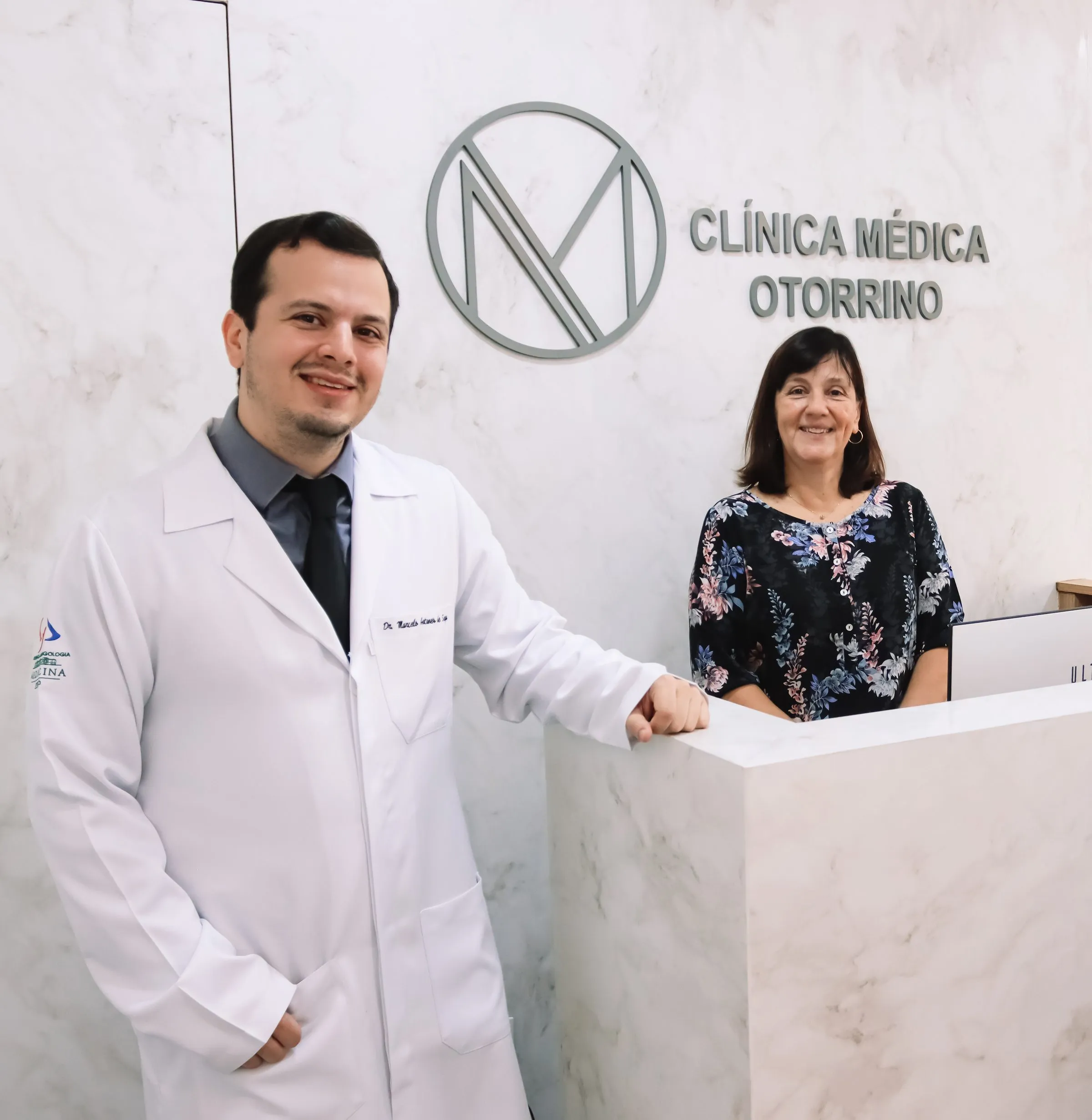 Dr. Marcelo e a secretária Marina na recepção da clínica